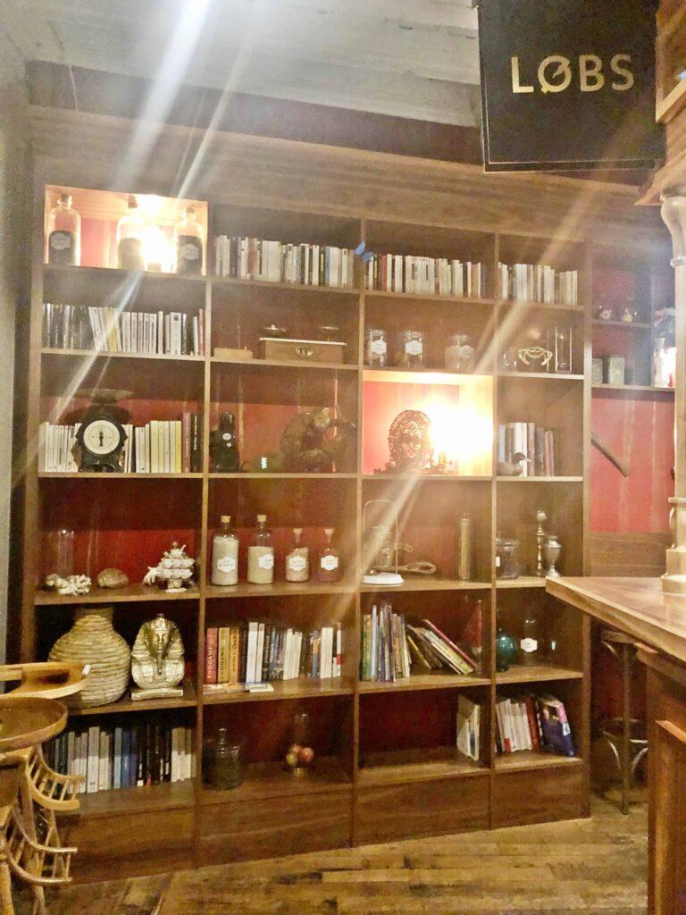 Interior decor booksheld at seating at Food Traboule Restaurant in Lyon
